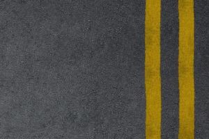 Road asphalt texture with yellow separation lines
