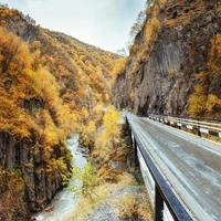 golden autumn landscape between the rocky mountains in Georgia. Stone road. Europe photo