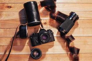 Old photo film and analog camera on table. Roll of photographic . Beautiful vintage design.