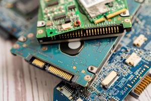 Technician repairing inside of mobile phone by soldering iron. Integrated Circuit. the concept of data, hardware, technology. photo