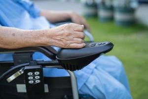 Asian senior or elderly old lady woman patient on electric wheelchair with remote control at nursing hospital ward, healthy strong medical concept photo