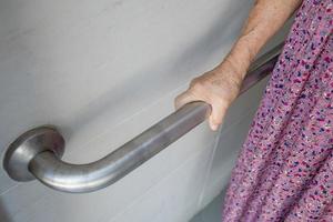 Asian senior or elderly old lady woman patient use toilet bathroom handle security in nursing hospital ward, healthy strong medical concept. photo