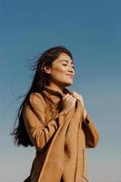 woman raises her hands as a sign of freedom and happiness photo