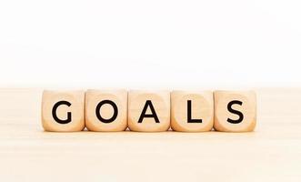 Goals word on wooden block shape. Copy space. White background photo