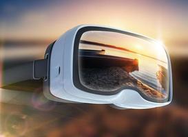 Virtual reality headset, double exposure, boat on the lake at sunset photo