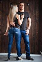 Young couple dancing latin music Bachata, merengue, salsa. Two elegance pose on cafe with brick walls photo