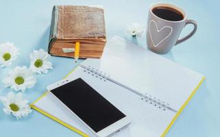 On the blue background notebook pencil, ruler and white flowers photo