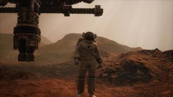 Spaceman walks on the red planet Mars. Space Mission video