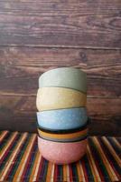 stack of colorful empty bowl on table photo