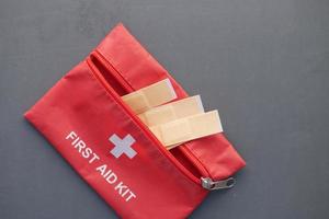 Close up of first aid kit on black background photo