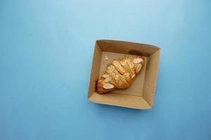 fresh baked croissant in a bow on table photo