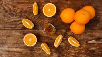 Jar of orange jam on wooden background from top view. Homemade marmalade photo