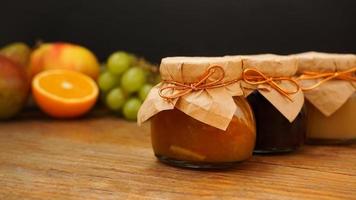 Home-made jam, selective focus. Jars with marmalade, confiture. Sweet dessert photo