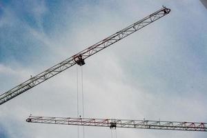 Two cranes in action for the construction of a lattice photo