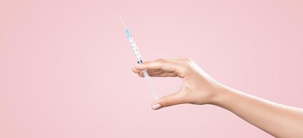 Hand holding syringe with vaccine against corona virus. photo