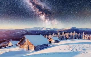 chalets in the mountains at night under the stars. Magic event in frosty day. In anticipation of the holiday