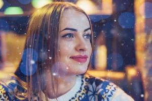 Young beautiful woman sitting in cafe, drinking coffee. Model looking up. Christmas, new year, Valentines day, winter holidays concept photo