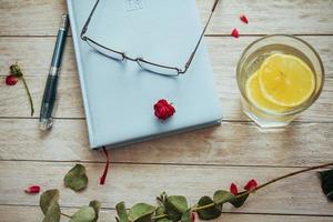 book glasses and flower petals photo