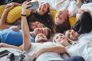 Group beautiful young people doing selfie lying on the floor, best friends girls and boys together having fun, posing emotional lifestyle  concept photo