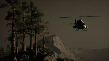 extreme slow motion flying helicopter near mountain forest video