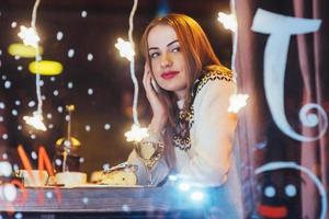 Young beautiful woman sitting in cafe, drinking wine. Christmas, new year, Valentines day, winter holidays concept photo