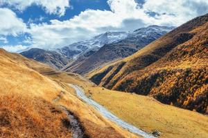 golden autumn landscape between the rocky mountains in Georgia. Stone road. Europe photo