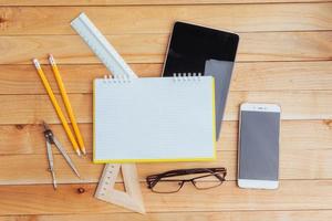 Top view of notebook, stationery, drawing tools and a few glasses. improvise. photo