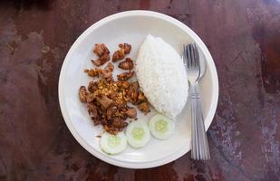 Fried pork with garlic and pepper and rice photo
