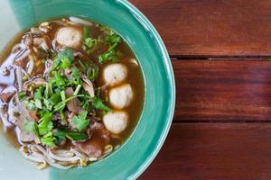 bowl of pungent thai pork noodle soup photo