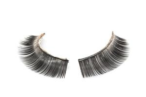 Use of  artificial eyelashes macro Isolated on white background photo