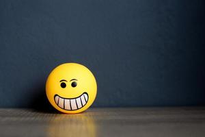 Smiley emoticon isolated on black background with copy space photo