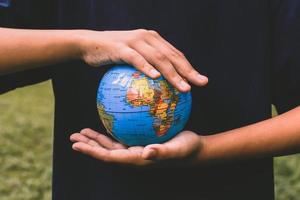 human hands holding Earth planet photo