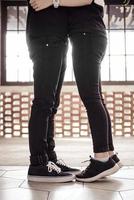 Couple in love with black jeans pants showing kissing gesture photo