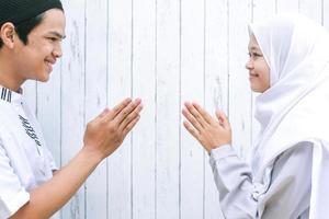 Muslim handshake by Young Asian Muslims and greet each other on Eid Mubarak, Eid Fitr, Eid Al-Fitr celebration photo