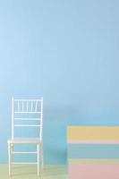 Minimalist interior with chair and colorful staircase on blue background photo