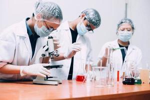 Researcher team work in laboratory using microscope and lab equipment. National Science Day, World Science Day photo