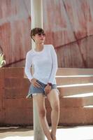 Mock up of white long sleeve t-shirt and short pants wearing by beautiful stylish short hair woman photo