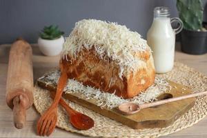 Delicious whole wheat bread with grated cheese on top photo