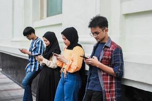 Group of friends watching smart mobile phones - Teenagers addiction to new technology trends - Concept of youth, tech, social and friendship