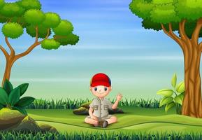 The scout boy sitting and waving in nature background vector