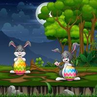 Happy bunnies holding a big Easter egg on the field vector