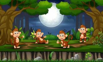 escena nocturna con muchos monos en el bosque vector