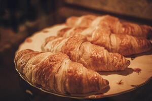 Freshly baked croissant on a plate. French food.