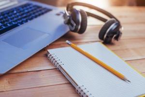 Laptop notebook headphones and olivchem on a light wooden background. photo