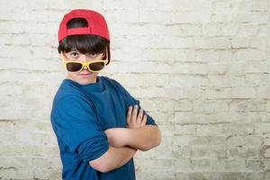 happy boy with cap and sunglasses photo