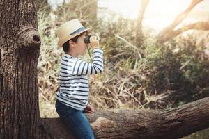 boy exploring the outdoors with binoculars photo