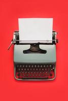 Vintage typewriter with white paper isolated photo