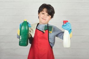 angry child with cleaning products photo