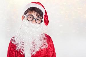 Boy dressed as Santa Claus photo