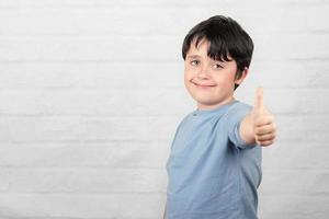 smiling child showing thumbs up photo